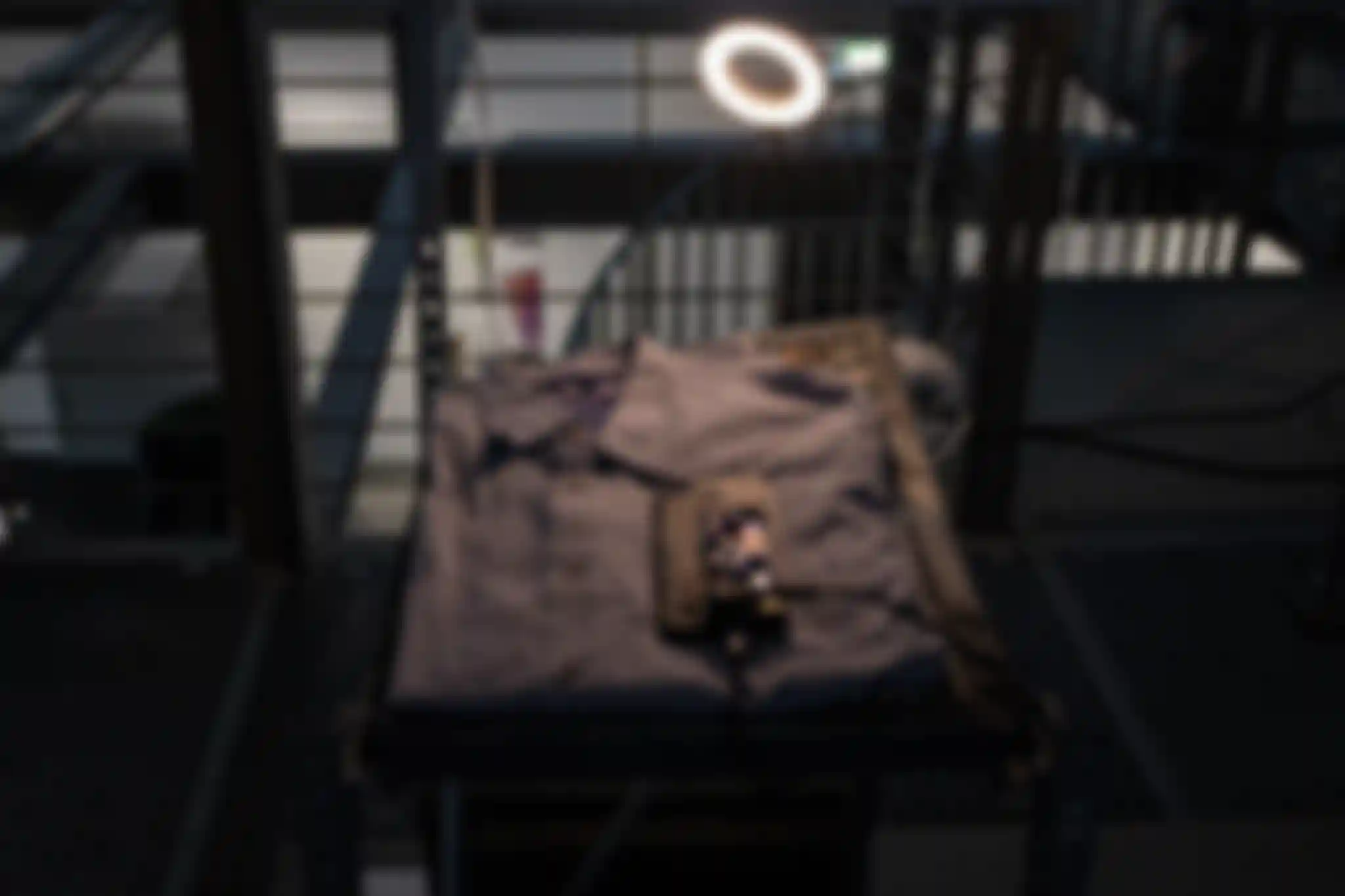 A folded shirt laying on a flat surface as part of the /sys/net/visible installation. A smartphone, powered by a Buck converter, is placed on top of the shirt.